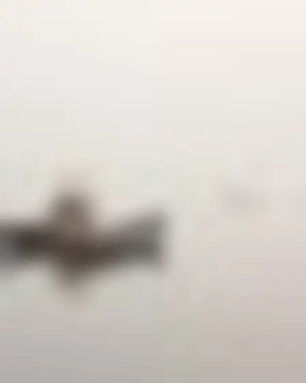 A professional fine art prompt: misty minimal landscape harbor boats, minimal abstract landscape in washed grey and warm beige with soft horizontal bands, faint distant forms and plaster texture. Optimised for GPT Image on a 2:3 canvas.